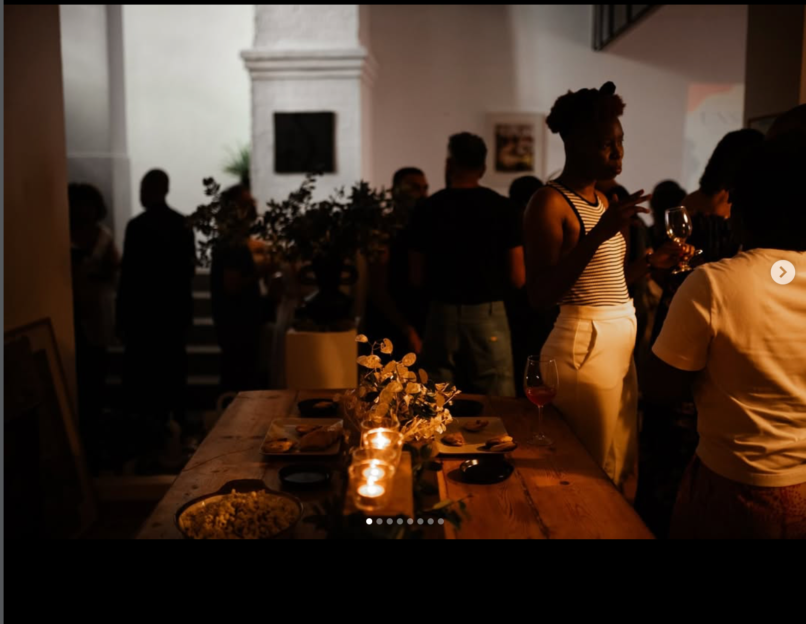 Guests gathered in M8triarch around a candlelit table